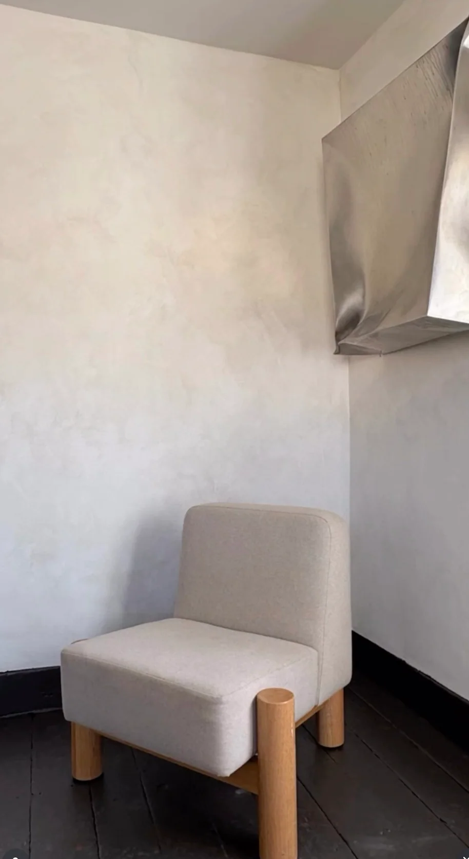 A chair and wall sculpture inside the Santa Fe gallery